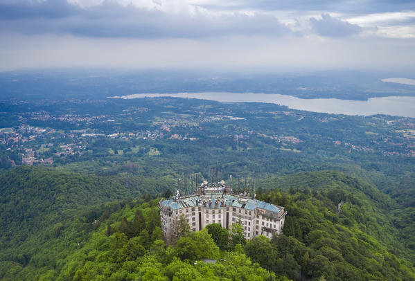 Aerial view of the abandoned Grand Hotel Campo dei Fiori in spring. Campo dei Fiori, Varese, Parco Campo dei Fiori, Lombardy, Italy.