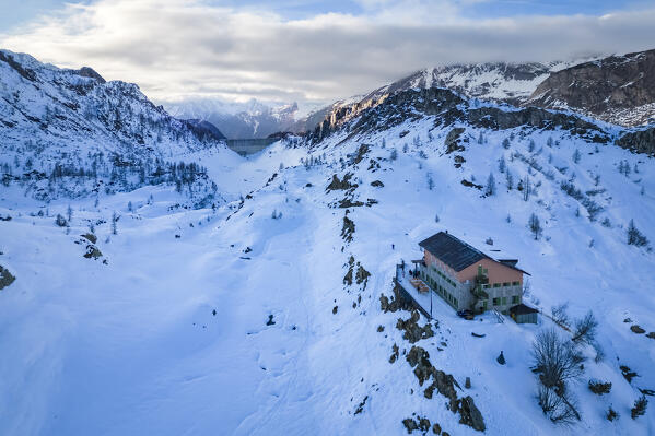 View of the Rifugio Calvi and Fregabolgia lake at sunset in winter. Carona, Val Brembana, Alpi Orobie, Bergamo, Bergamo Province, Lombardy, Italy, Europe.
