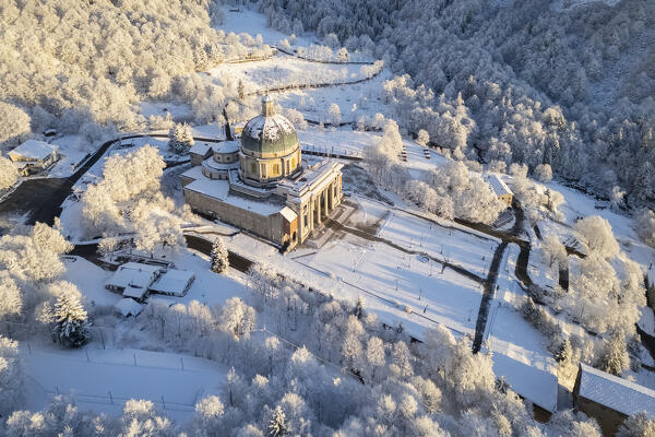 Aerial view of the dome of the upper basilica of the Sanctuary of Oropa in winter at sunrise. Biella, Biella district, Piedmont, Italy, Europe.