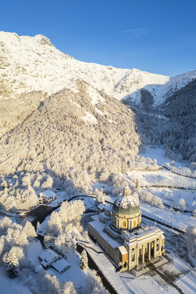 Aerial view of the dome of the upper basilica of the Sanctuary of Oropa in winter at sunrise. Biella, Biella district, Piedmont, Italy, Europe.