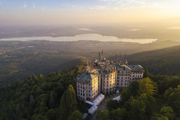 Aerial view of the abandoned Grand Hotel Campo dei Fiori in summer. Campo dei Fiori, Varese, Parco Campo dei Fiori, Lombardy, Italy.