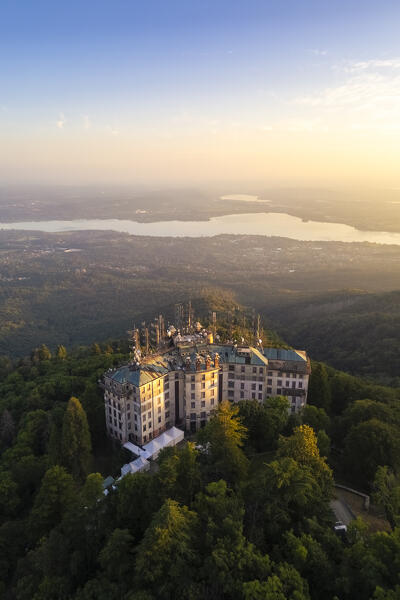 Aerial view of the abandoned Grand Hotel Campo dei Fiori in summer. Campo dei Fiori, Varese, Parco Campo dei Fiori, Lombardy, Italy.