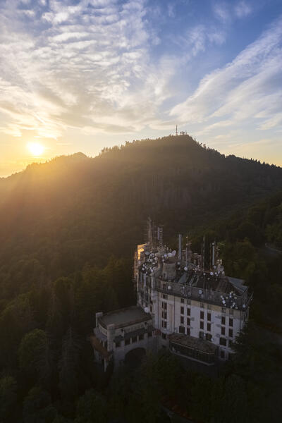 Aerial view of the abandoned Grand Hotel Campo dei Fiori in summer. Campo dei Fiori, Varese, Parco Campo dei Fiori, Lombardy, Italy.