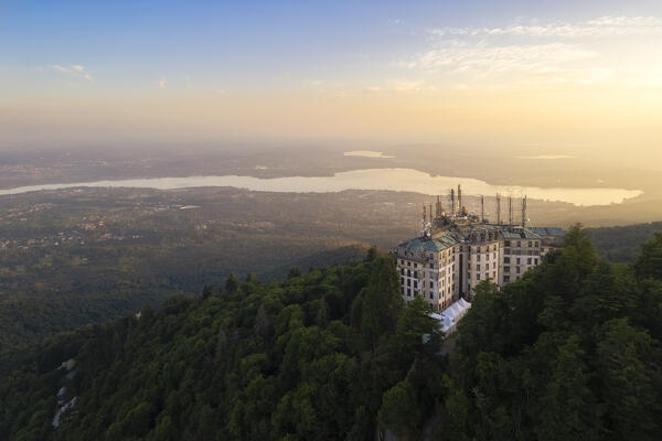 Aerial view of the abandoned Grand Hotel Campo dei Fiori in summer. Campo dei Fiori, Varese, Parco Campo dei Fiori, Lombardy, Italy.