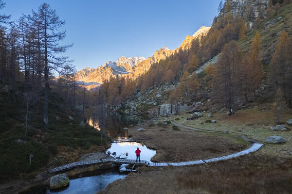 Autumnal view at sunrise of the Lago delle Streghe lake at Crampiolo, Alpe Devero. Alpe Devero, Devero valley, Antigorio valley, Ossola valley, Piedmont, Verbano Cusio Ossola district, Italy.