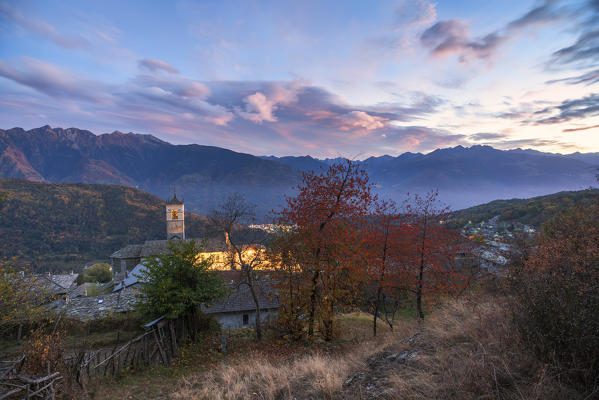 Sunset over the old church of Caspiano and Rhaetian Alps, Costiera dei Cech, Sondrio province, lower Valtellina, Lombardy, Italy