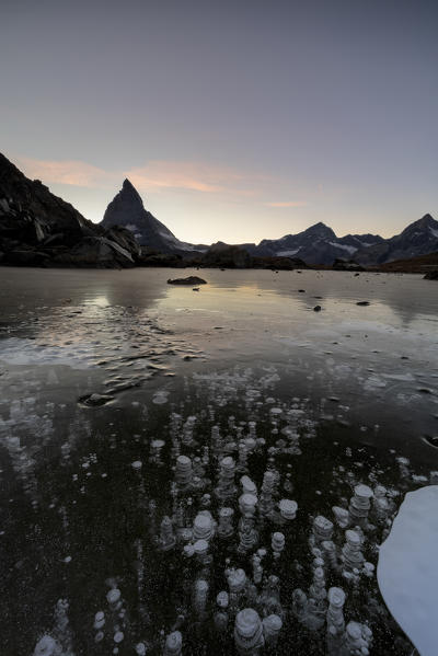 Ice bubbles trapped in lake Riffelsee with Matterhorn in background, Zermatt, canton of Valais, Switzerland