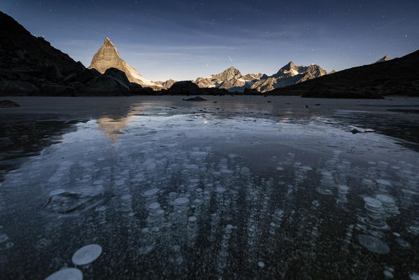 Ice bubbles trapped in lake Riffelsee with Matterhorn in background, Zermatt, canton of Valais, Switzerland