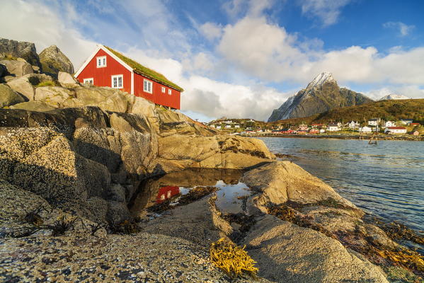 Iconic Rorbu with grass roof by the sea, Reine, Moskenes, Nordland, Lofoten Islands, Norway