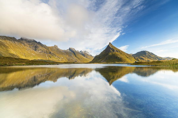 Panoramic of mount Volanstinden mirrored in water, Fredvang, Nordland county, Lofoten Islands, Norway