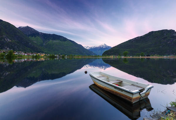 Boat moored in lake of Novate Mezzola at sunrise, Valchiavenna, Sondrio province, Valtellina, Lombardy, Italy