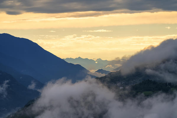 Low Clouds over Teglio at sunset, Sondrio province, Valtellina, Lombardy, Italy