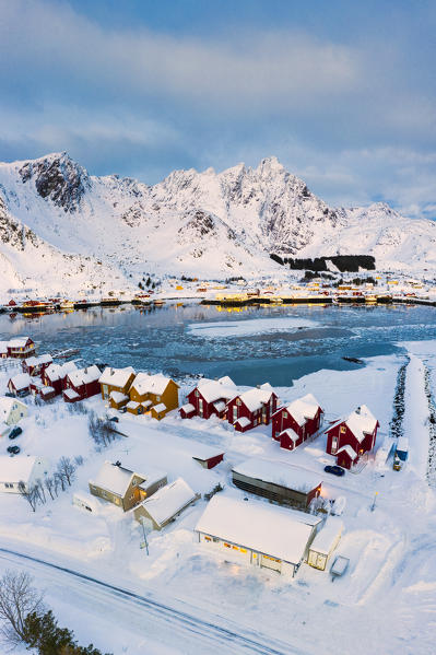 Aerial panoramic of traditional Rorbu overlooking the frozen sea, Ballstad, Vestvagoy, Lofoten Islands, Norway