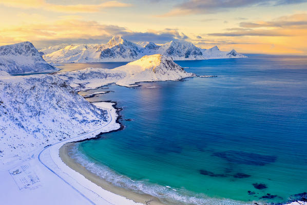 Aerial view of turquoise sea around Haukland beach covered with snow, Vestvagoy, Nordland, Lofoten Islands, Norway