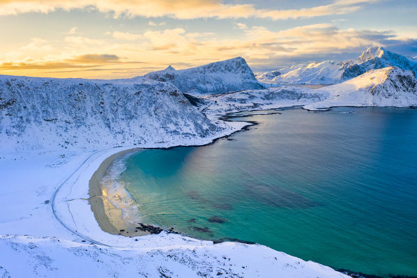 Aerial view of Haukland beach surrounded by snowy peaks, Vestvagoy, Nordland, Lofoten Islands, Norway