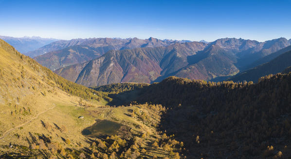 Aerial panoramic of Lago di Culino and woods in autumn, Orobie Alps, Val Gerola, Valtellina, Sondrio province, Lombardy, Italy