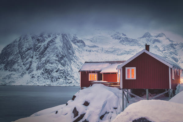 Red fisherman's cabins covered with snow, Hamnoy, Nordland, Lofoten Islands, Norway