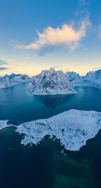 Aerial panoramic of snowy mountains and fjord at dawn, Reine, Nordland, Lofoten Islands, Norway