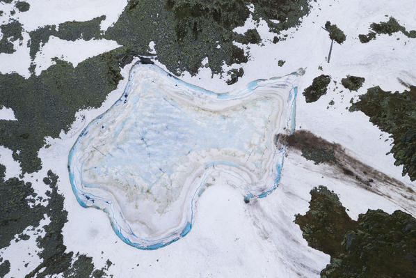 Ice melting at Lago Nero from above, Montespluga, Valchiavenna, Valle Spluga, Valtellina, Lombardy, Italy