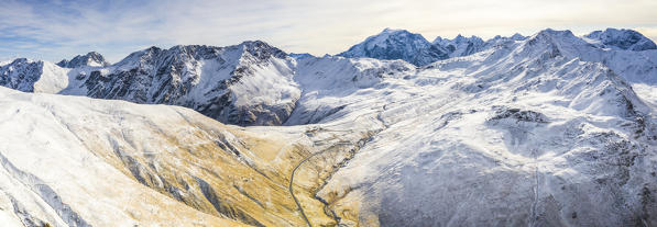 Aerial panoramic of mountain road towards Stelvio Pass and Ortles mount, Braulio Valley, Bormio, Valtellina, Lombardy, Italy