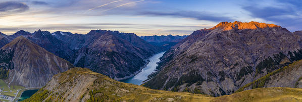 Autumnal sunset over Pizzo del Ferro peak and lake of Livigno, aerial view, Sondrio province, Valtellina, Lombardy, Italy