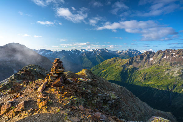 Sun over the mountain range in summer seen from top of Monte Gaviola, Gavia Pass, Valtellina, Lombardy, Italy