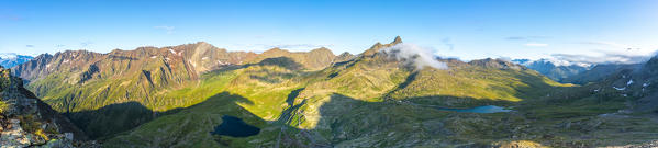 Panoramic of clear sky in summer over mountains and lakes from top of Monte Gaviola, Gavia Pass, Valtellina, Lombardy, Italy