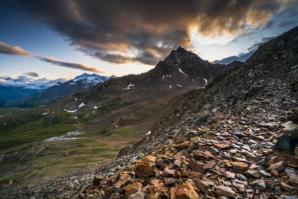 Dramatic sky at sunrise on rocky peak Corno dei Tre Signori seen from Gavia Pass, Valtellina, Sondrio province, Lombardy, Italy