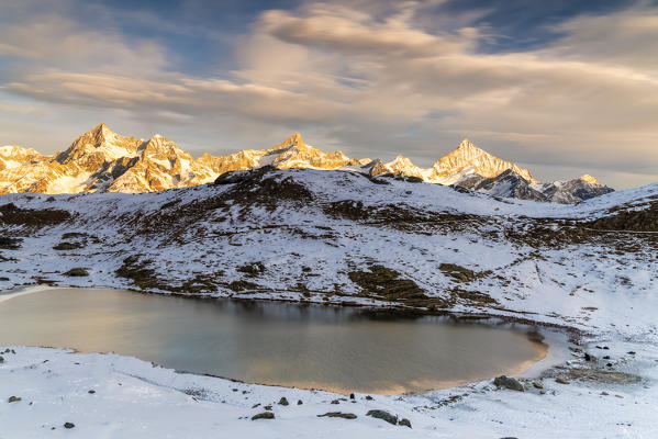 Ober Gabelhorn, Zinalrothorn and Weisshorn seen from the frozen Riffelsee lake, Zermatt, canton of Valais, Switzerland