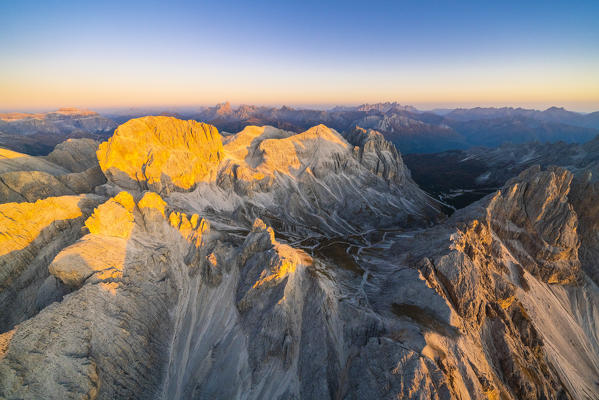 Catinaccio Group lit by warm sunset in autumn, aerial view Sciliar-Catinaccio Natural Park, Dolomites, South Tyrol, Italy