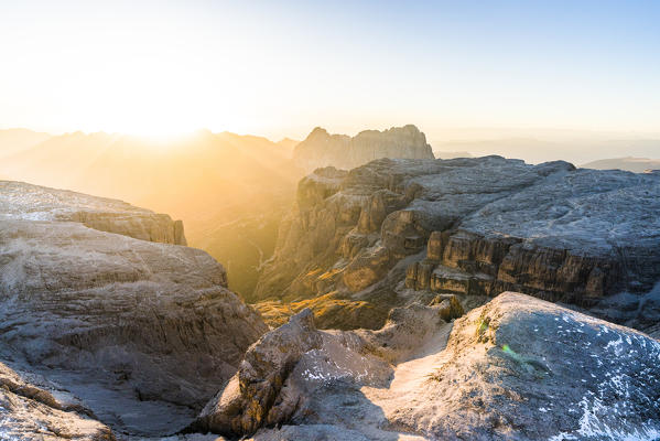 Mist at sunset over Sella Group and Sass Pordoi in autumn, aerial view, Val Gardena, Val di Fassa, Dolomites, South Tyrol, Italy