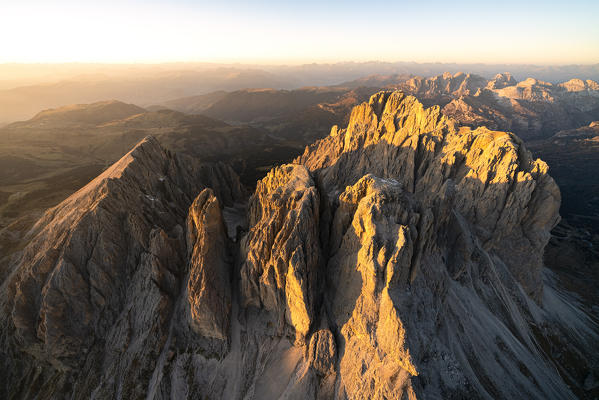 Aerial view of Sassolungo and Sassopiatto at sunset in autumn, Val Gardena, Val di Fassa, Dolomites, South Tyrol, Italy