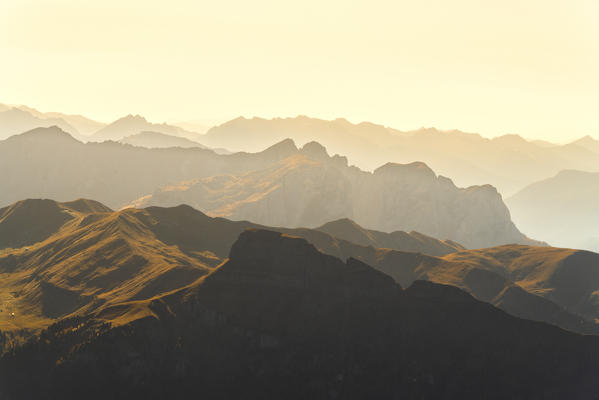 Mountains silhouette of Val di Fassa at sunset in autumn seen from Sass Pordoi, Dolomites, Trentino, Italy