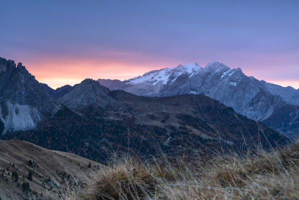 Autumn sunrise over Marmolada and Pordoi Pass from Passo Sella, Val Gardena, Val di Fassa, Dolomites, South Tyrol, Italy