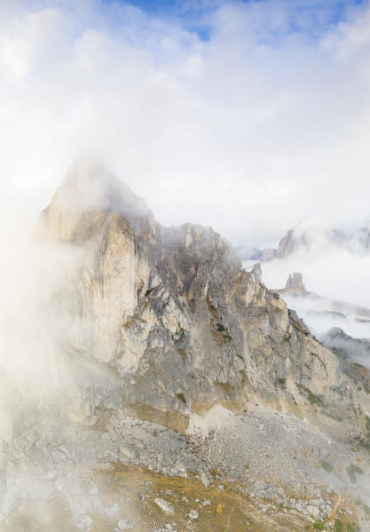 Fog over the majestic Ra Gusela and Cinque Torri mountains in autumn, aerial view, Giau Pass, Dolomites, Belluno, Veneto, Italy