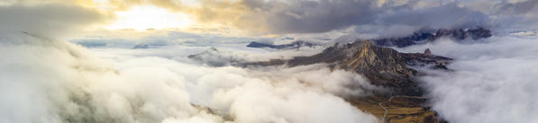 Aerial panoramic of foggy sky at sunset over Cinque Torri and Giau Pass in autumn, Dolomites, Belluno, Veneto, Italy