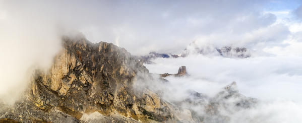 Aerial panoramic of Cinque Torri and Tofane Group covered by autumn fog, Giau Pass, Dolomites, Belluno province, Veneto, Italy