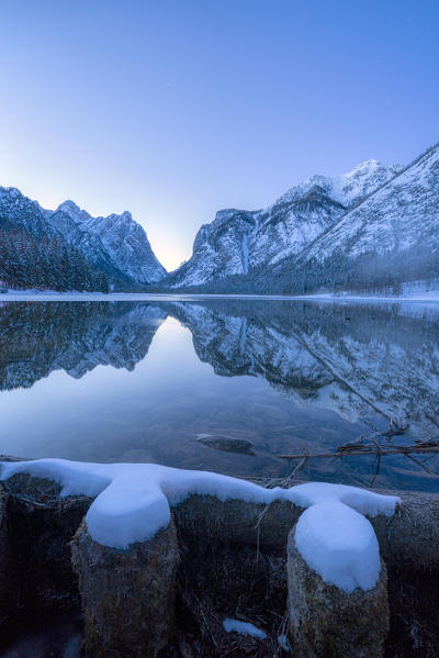 Dusk over Lake Dobbiaco and mountains in winter, Dobbiaco, Val Pusteria, Dolomites, Bolzano province, South Tyrol, Italy