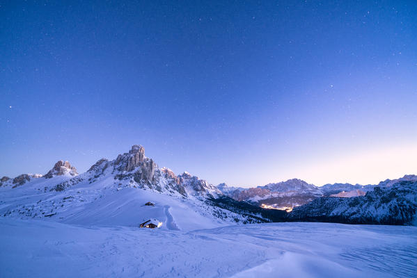 Dusk over Ra Gusela, Monte Cristallo and Cortina d'Ampezzo covered with snow, Giau Pass, Dolomites, Belluno province, Veneto, Italy