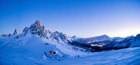 Panoramic of Ra Gusela, Monte Cristallo and Cortina d'Ampezzo covered with snow at dusk, Giau Pass, Dolomites, Veneto, Italy