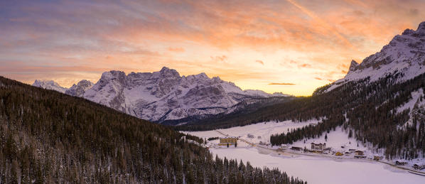 Panoramic of the sky at sunset over Sorapis group and Lake Misurina covered with snow, Dolomites, Belluno, Veneto, Italy