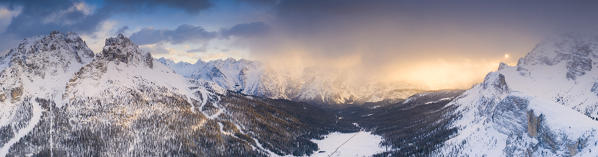 Panoramic of Cadini di Misurina and Sorapis covered with snow at sunset, aerial view, Dolomites, Auronzo di Cadore, Veneto, Italy