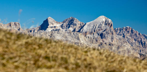 The Tofane group with Mount Cristallo from the meadows by the Falzarego Pass in their autumnal colours Dolomites Veneto Italy Europe