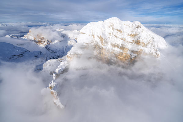 Winter aerial view of Tofana di Mezzo and cableway Freccia nel Cielo in the mist, Dolomites, Belluno province, Veneto, Italy