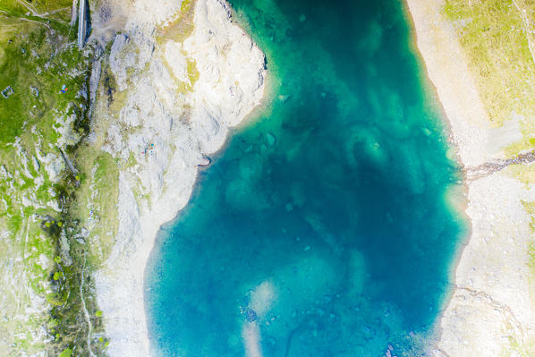 Turquoise water of Pescegallo lake from above, Orobie Alps, Valgerola, Valtellina, Sondrio province, Lombardy, Italy