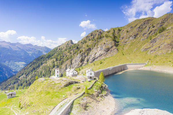 Pescegallo lake and dam during a sunny spring day, Orobie Alps, Valgerola, Valtellina, Sondrio province, Lombardy, Italy