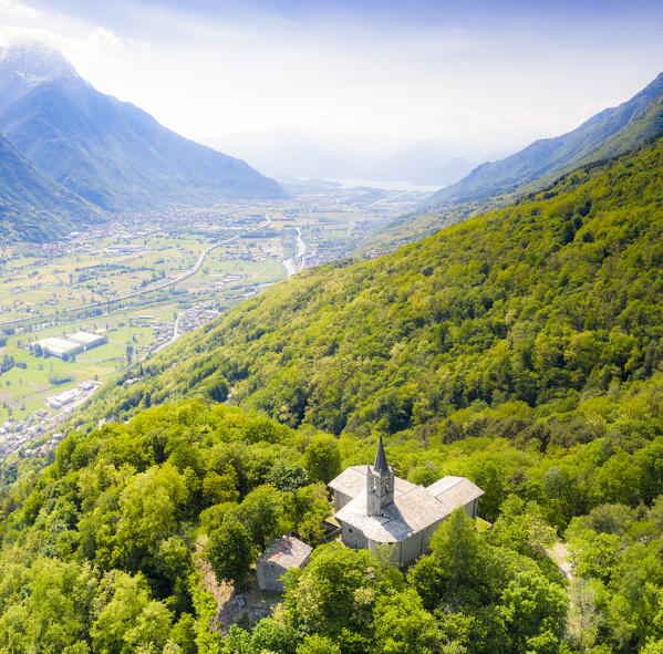 Bell tower and church of San Giovanni di Bioggio, aerial view, Costiera dei Cech, Valtellina, Sondrio province, Lombardy, Italy