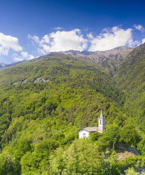 Aerial panoramic of San Giovanni di Bioggio church in summer, Costiera dei Cech, Valtellina, Sondrio province, Lombardy, Italy