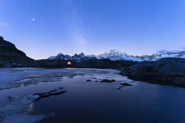 Tent under the Milky Way with Monte Disgrazia in background, Alpe Fora, Valmalenco, Sondrio province, Lombardy, Italy