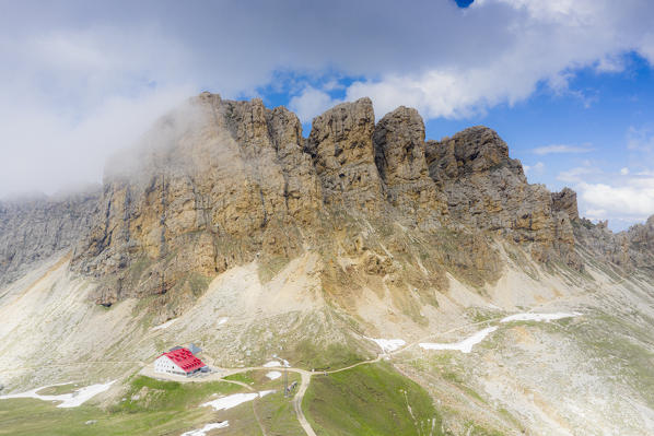 Clouds over Alpe di Tires hut at feet of Denti di Terrarossa (Rosszahne), aerial view, Dolomites, Trentino Alto Adige, Italy